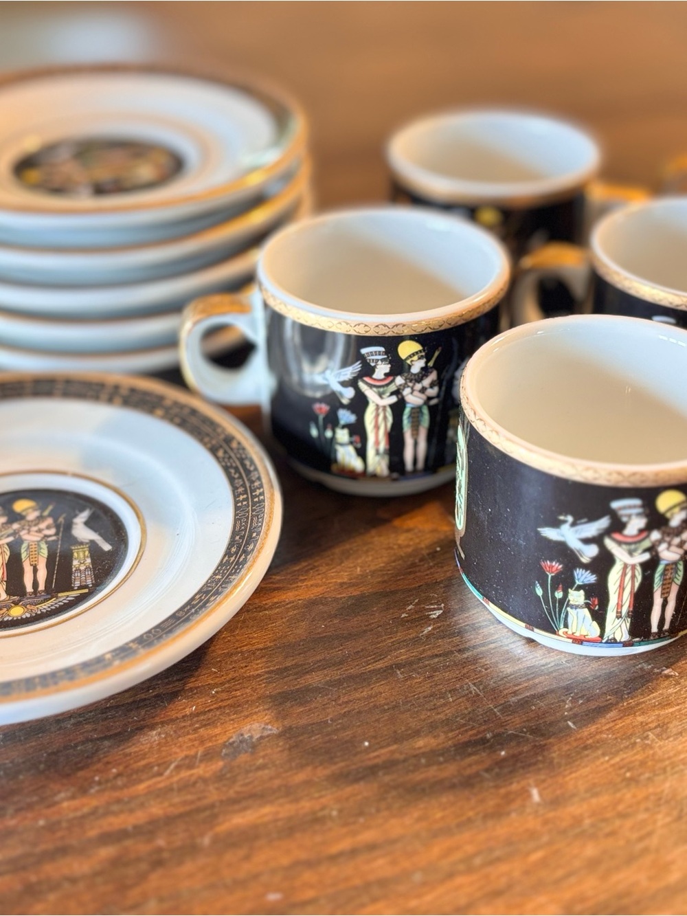 Black Porcelain Coffee Cups and Saucers with Egyptian Motif (11 pcs)